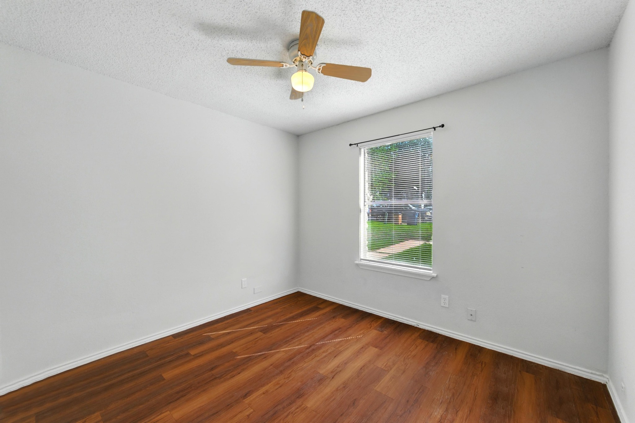 5707 Spring Meadow Road Austin, TX 78744 - Photo 17 of 21 a view of empty room with wooden floor and fan