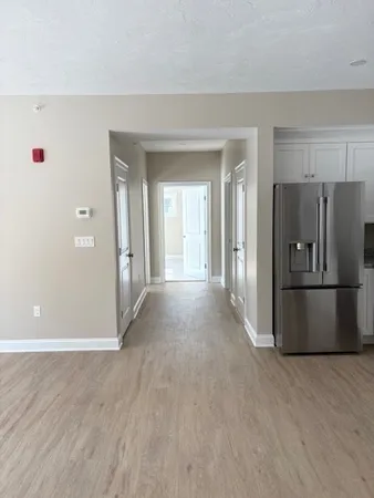 a view of a kitchen with a refrigerator and a stove top oven