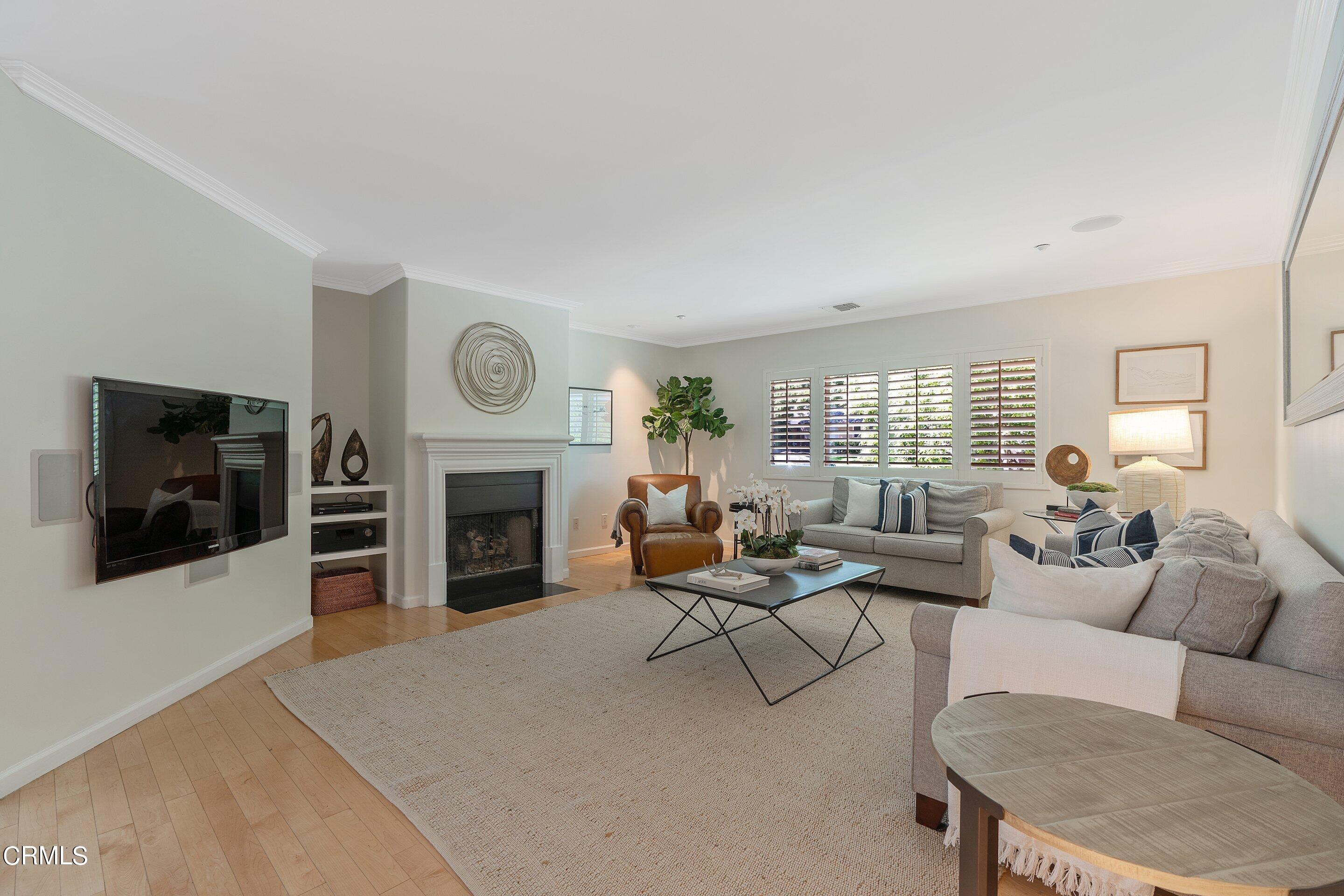 3710 Cedarbend Drive La Crescenta, CA 91214 - Photo 11 of 73 a living room with furniture a flat screen tv and a fireplace