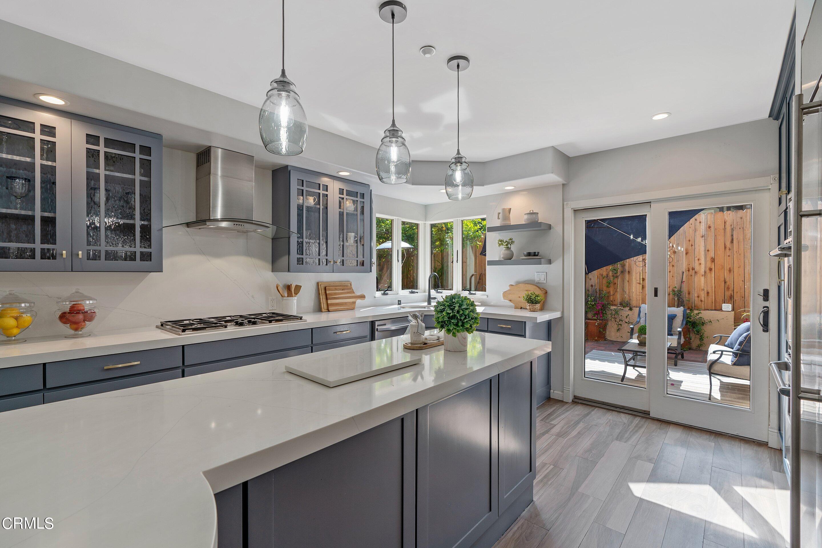 3710 Cedarbend Drive La Crescenta, CA 91214 - Photo 17 of 73 a kitchen with stainless steel appliances granite countertop a sink a stove and a wooden floors