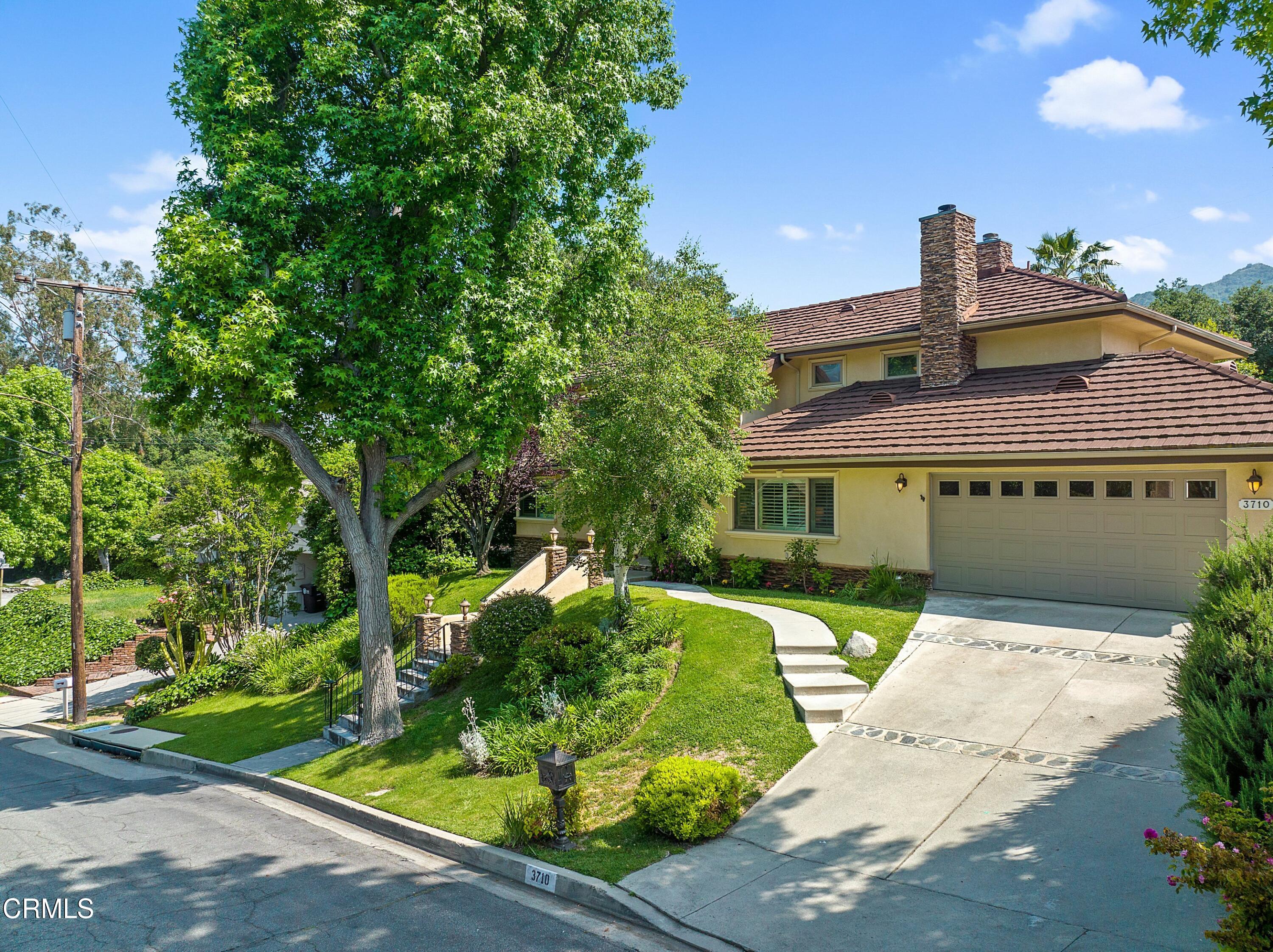 3710 Cedarbend Drive La Crescenta, CA 91214 - Photo 2 of 73 a front view of a house with a garden