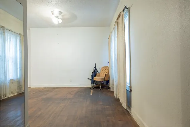 an empty room with wooden floor and a window