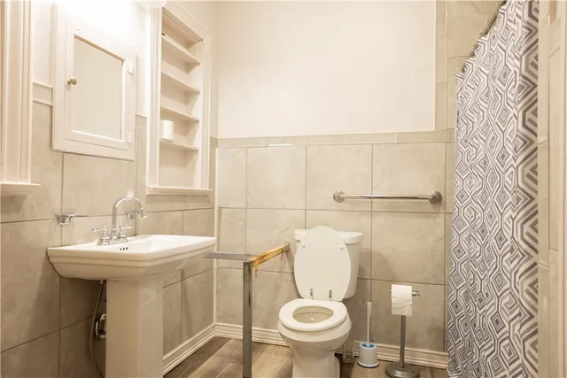 a bathroom with a sink toilet and mirror