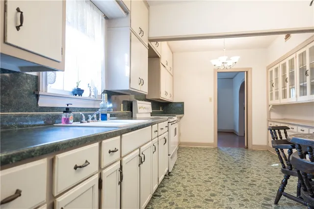 a kitchen with stainless steel appliances granite countertop a refrigerator and a stove