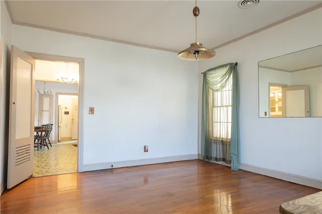 a view of an entryway with wooden floor and a livingroom