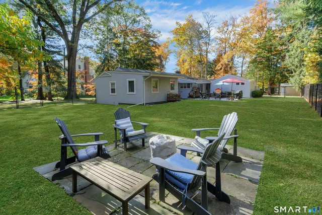 a view of a house with a yard and sitting area