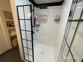 a bathroom with a shower and a mirror