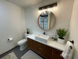 219 East Main Mossyrock, WA 98564 - Photo 12 of 28 a bathroom with a toilet a sink and mirror