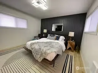 a bed sitting in a bedroom next to a window