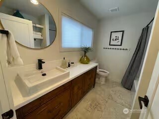 219 East Main Mossyrock, WA 98564 - Photo 15 of 28 a bathroom with a double vanity sink mirror and toilet