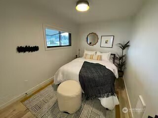 219 East Main Mossyrock, WA 98564 - Photo 16 of 28 a bedroom with a bed and painting on the wall