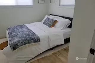 a bedroom with a bed and a window