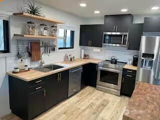 219 East Main Mossyrock, WA 98564 - Photo 3 of 28 a kitchen with stainless steel appliances granite countertop a sink stove and refrigerator