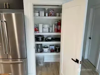 a kitchen with a refrigerator and cabinets