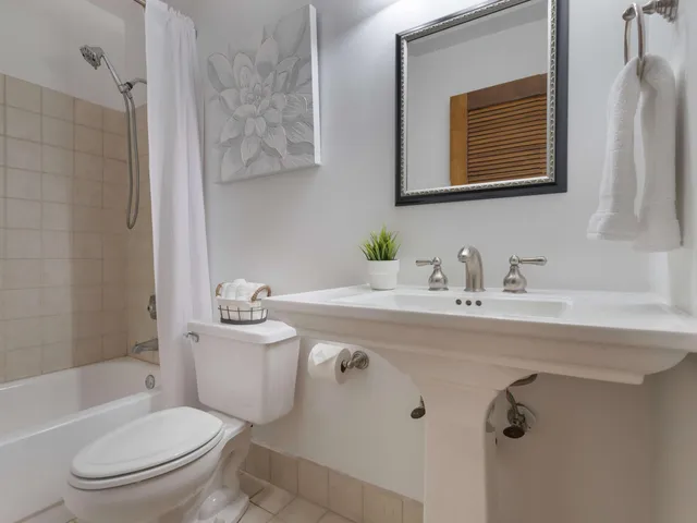 a bedroom with a bed and a ceiling fan