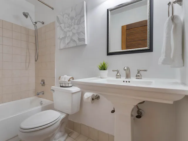 a kitchen with stainless steel appliances granite countertop a refrigerator a stove a sink a dining table and chairs with wooden floor