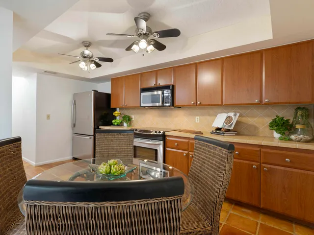 a dining room with furniture a chandelier and window