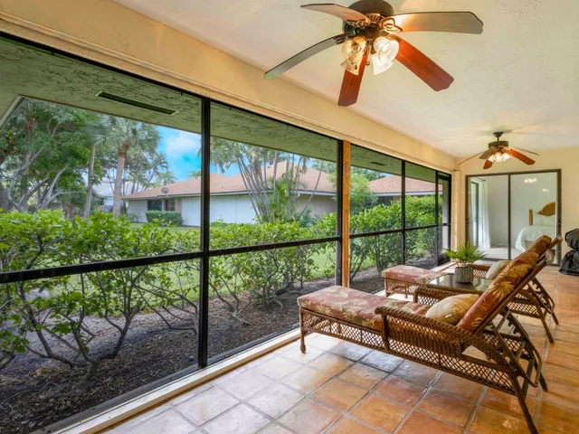 a view of a workspace with furniture and bookshelf