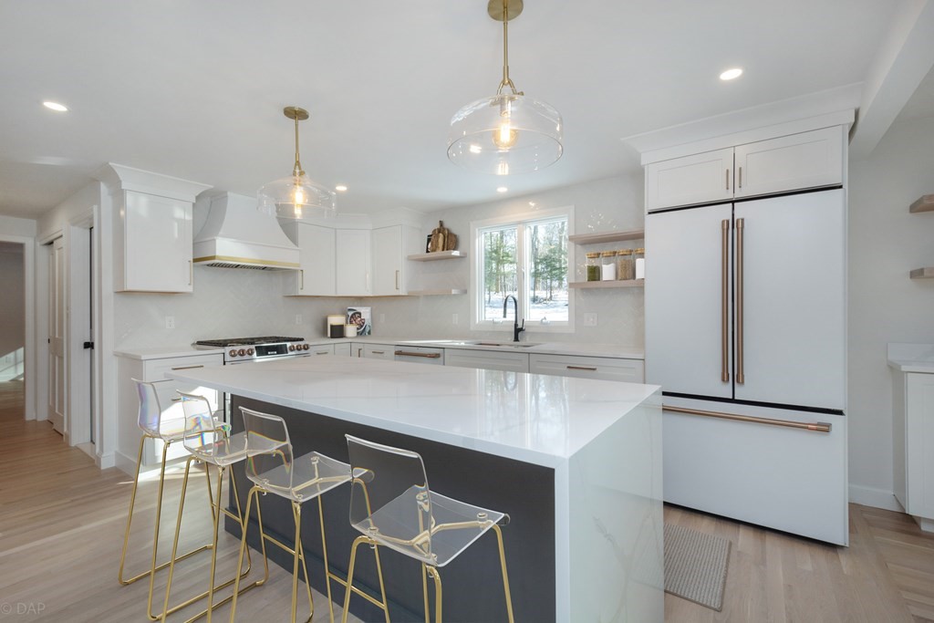 143 Hillcrest Road Concord, MA 01742 - Photo 12 of 42 a kitchen with kitchen island a sink appliances and cabinets