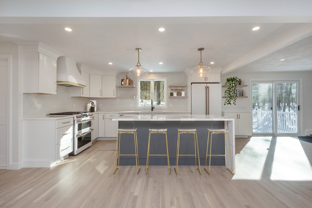 143 Hillcrest Road Concord, MA 01742 - Photo 13 of 42 a large kitchen with kitchen island granite countertop a large counter top space a sink stainless steel appliances and cabinets