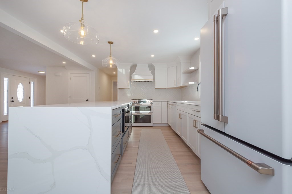 143 Hillcrest Road Concord, MA 01742 - Photo 15 of 42 a view of a kitchen with kitchen island a sink stainless steel appliances and cabinets