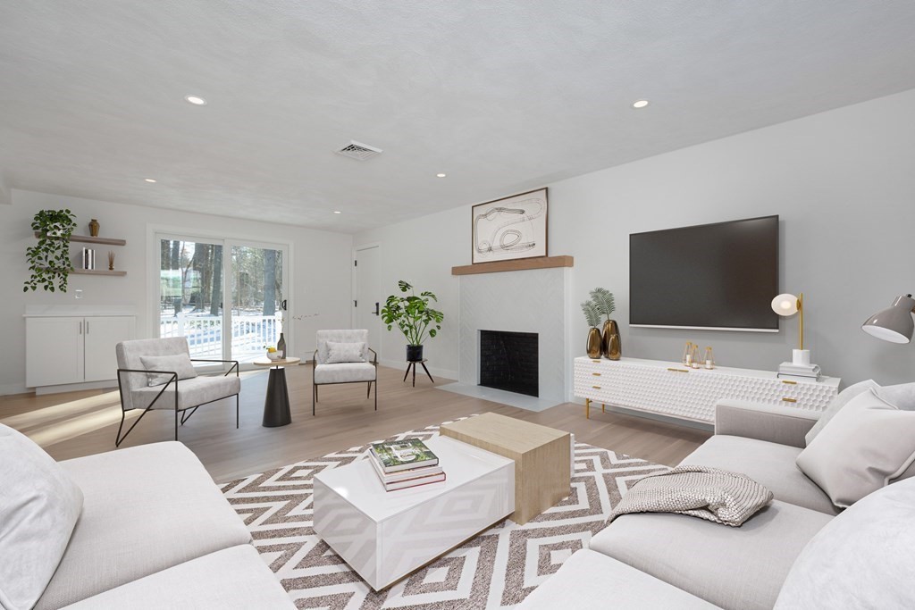 143 Hillcrest Road Concord, MA 01742 - Photo 17 of 42 a living room with furniture a rug and a flat screen tv