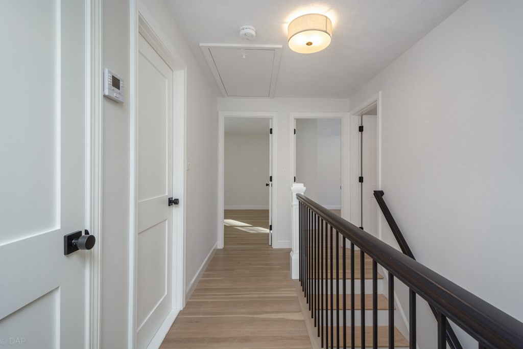 143 Hillcrest Road Concord, MA 01742 - Photo 20 of 42 a view of a hallway with wooden floor and stairs