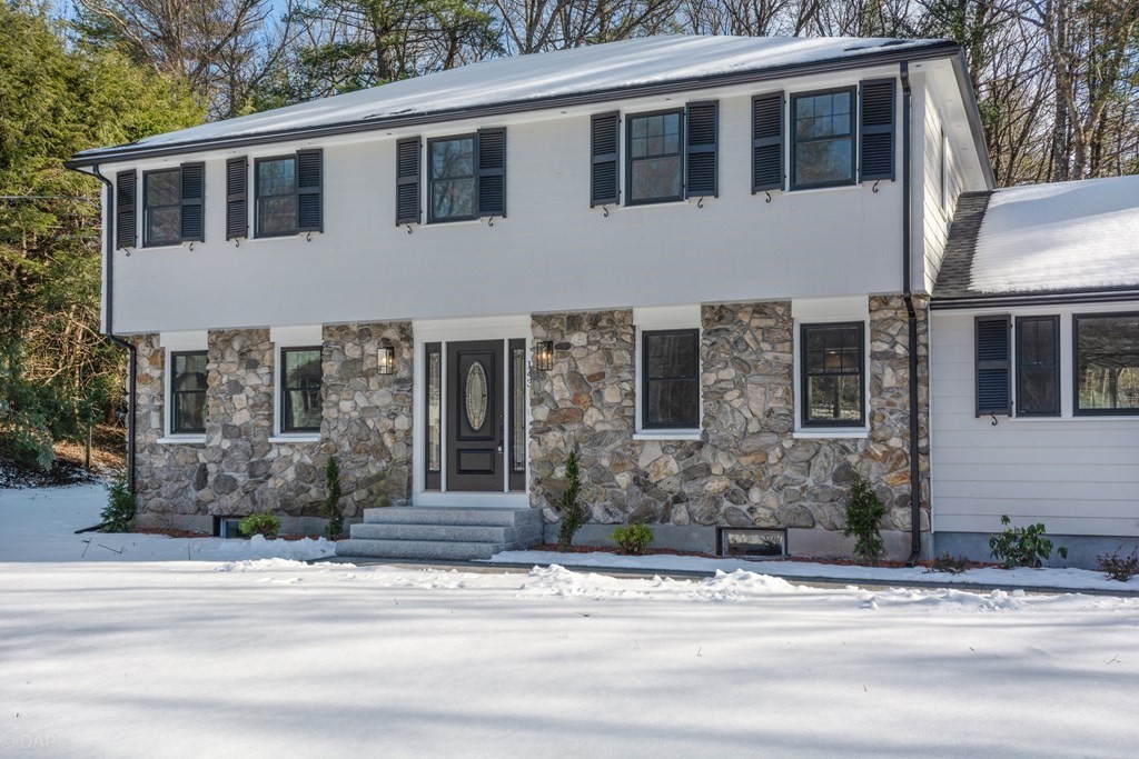 143 Hillcrest Road Concord, MA 01742 - Photo 2 of 42 a front view of a house with a yard and garage