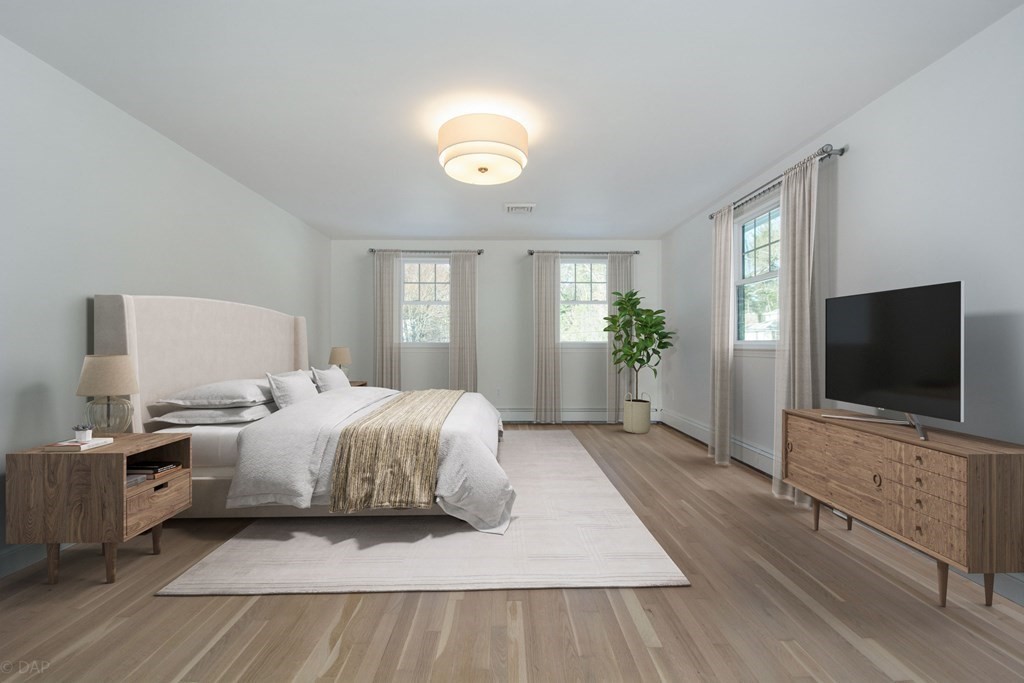 143 Hillcrest Road Concord, MA 01742 - Photo 21 of 42 a bedroom with a bed and a flat screen tv