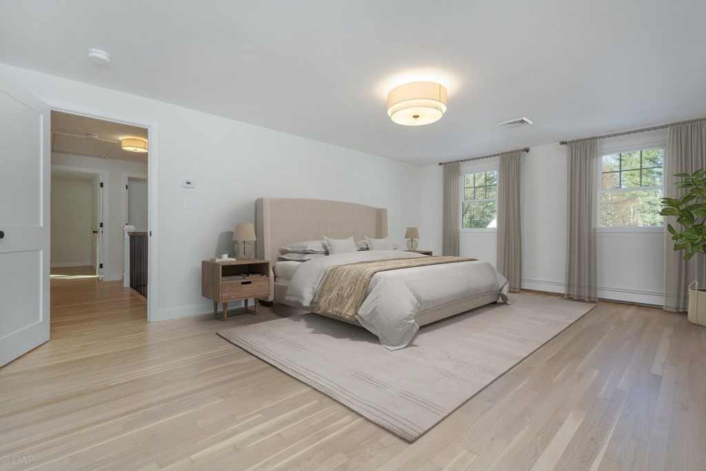 143 Hillcrest Road Concord, MA 01742 - Photo 22 of 42 a bedroom with a bed and a chandelier