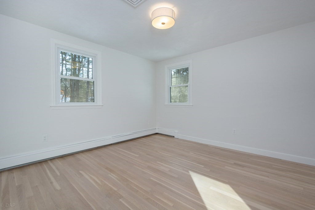143 Hillcrest Road Concord, MA 01742 - Photo 30 of 42 wooden floor in an empty room with a window