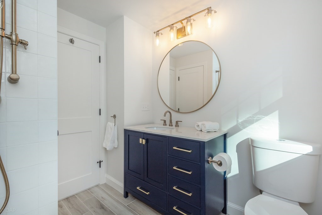 143 Hillcrest Road Concord, MA 01742 - Photo 32 of 42 a bathroom with a toilet sink vanity granite and a mirror