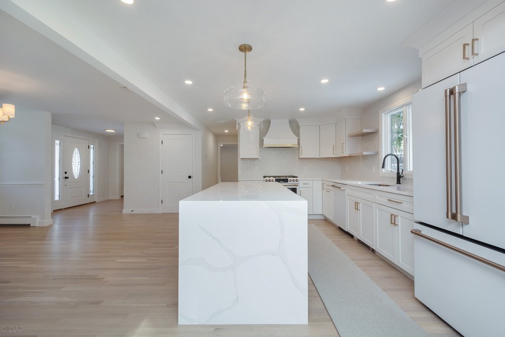 143 Hillcrest Road Concord, MA 01742 - Photo 9 of 42 a large white kitchen with lots of counter space wooden floor and appliances