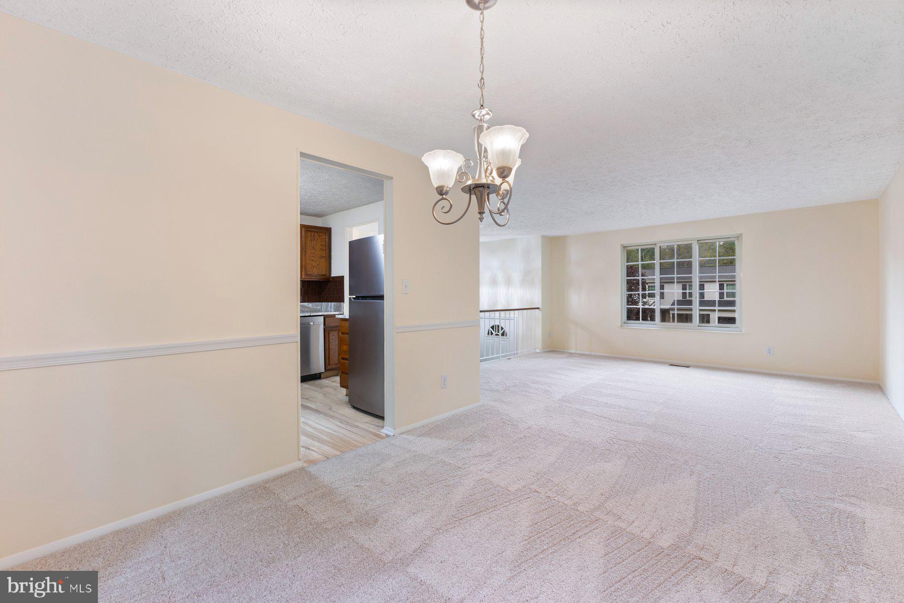 8011 Treasure Tree Court Springfield, VA 22153 - Photo 14 of 31 a view of a big room with windows and chandelier fan