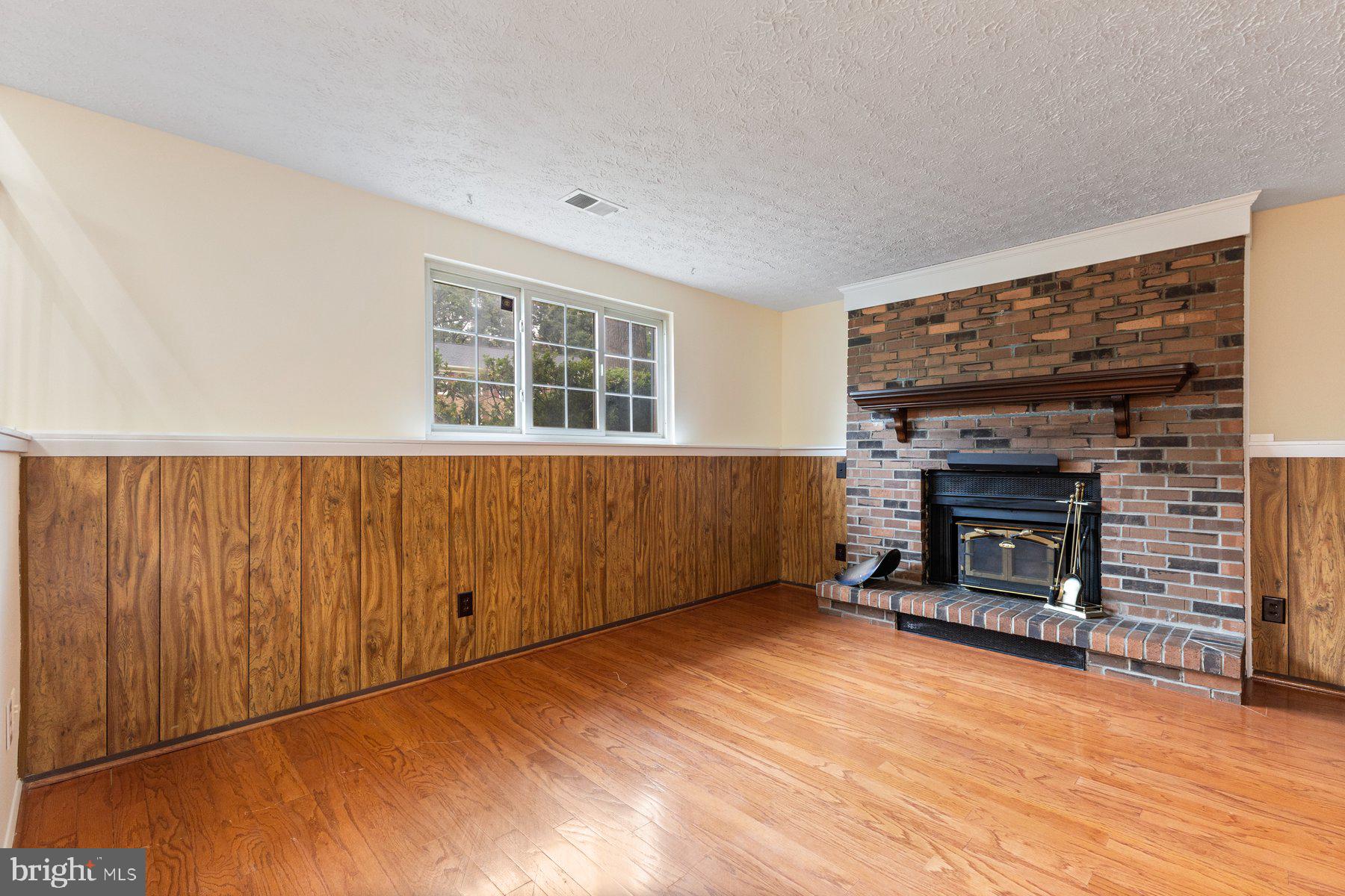 8011 Treasure Tree Court Springfield, VA 22153 - Photo 24 of 31 an empty room with windows and fireplace