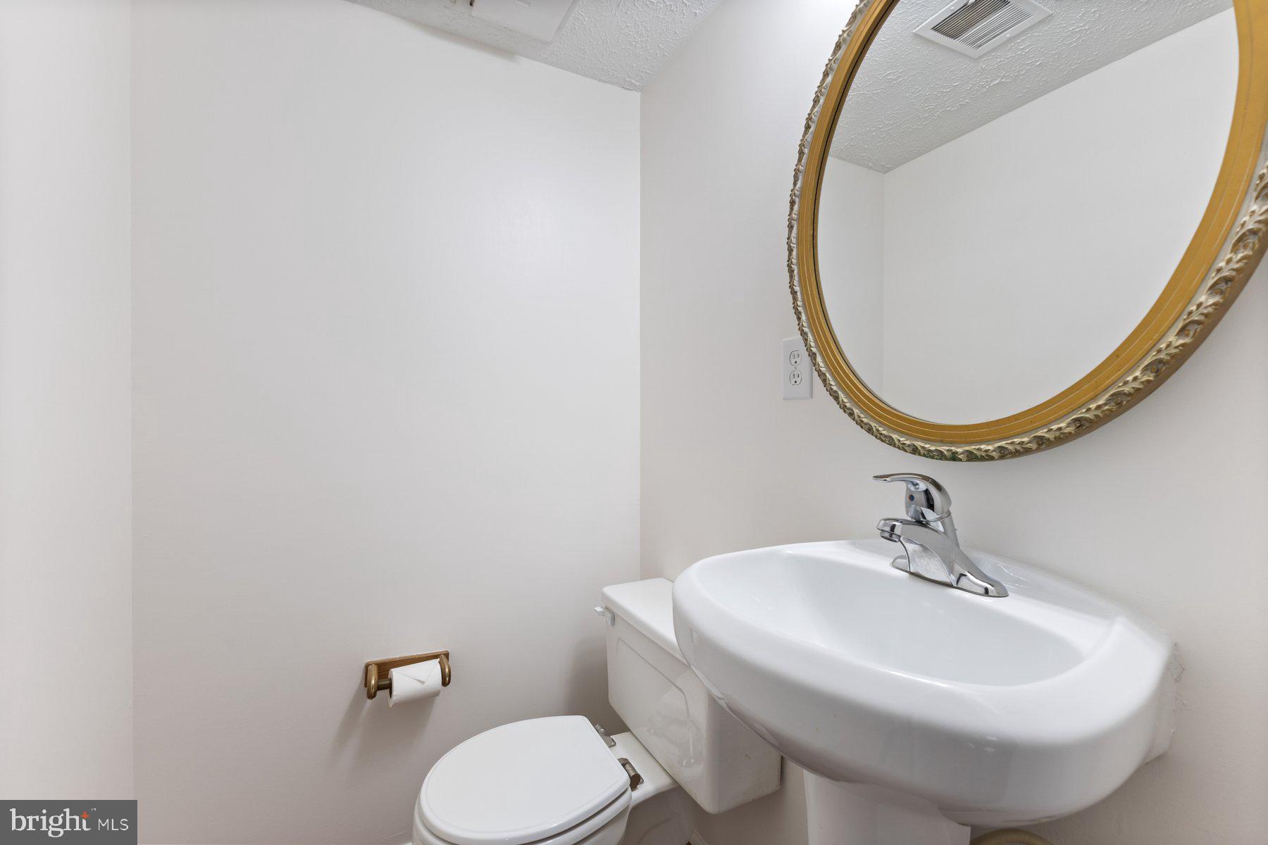 8011 Treasure Tree Court Springfield, VA 22153 - Photo 26 of 31 a bathroom with a sink and a mirror