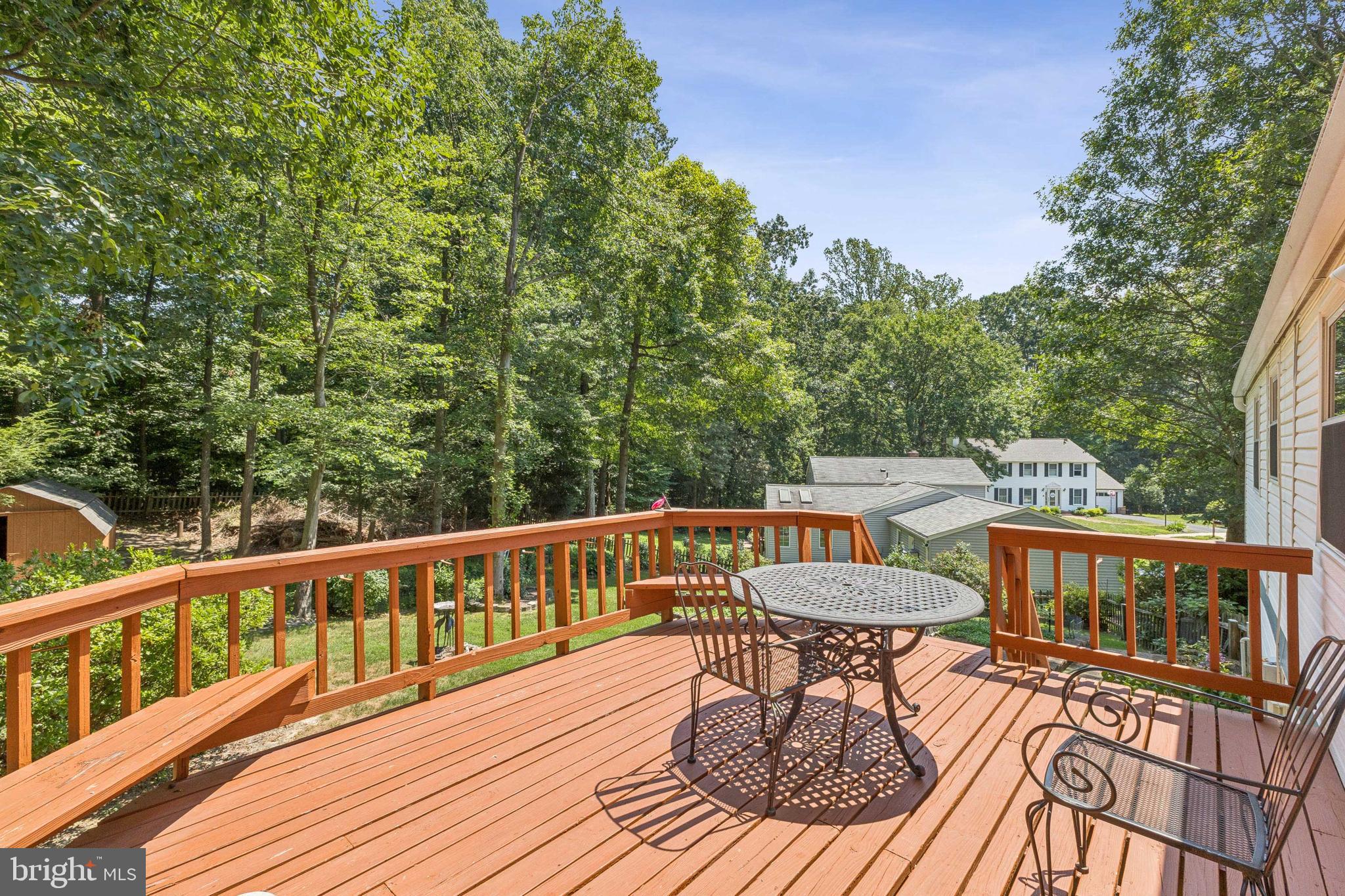 8011 Treasure Tree Court Springfield, VA 22153 - Photo 8 of 31 a balcony with wooden floor and outdoor seating