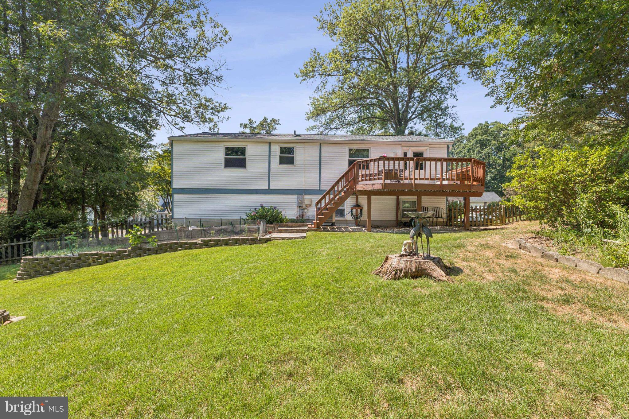 8011 Treasure Tree Court Springfield, VA 22153 - Photo 9 of 31 a view of a house with backyard and a tree
