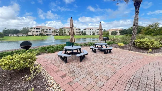 a view of roof deck with table and chairs