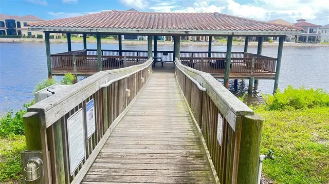 a living room with furniture a large window and a dining table