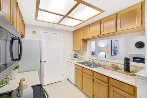 a spacious bathroom with a granite countertop sink a mirror a bathtub and shower