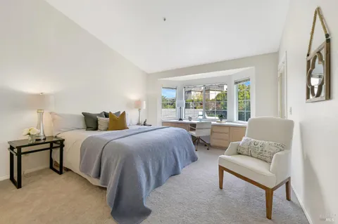 a bedroom with a bed and a couch