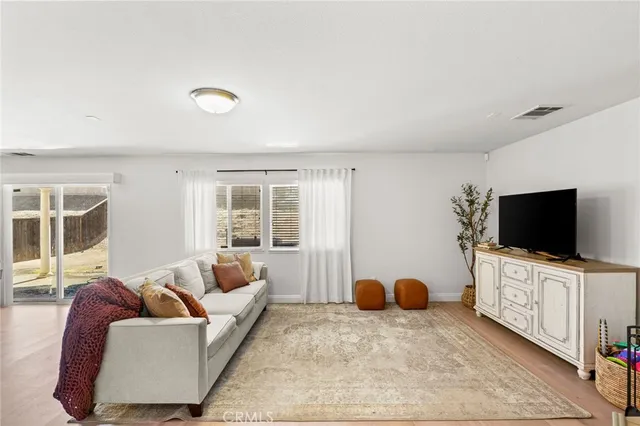 a bedroom with furniture and a flat screen tv