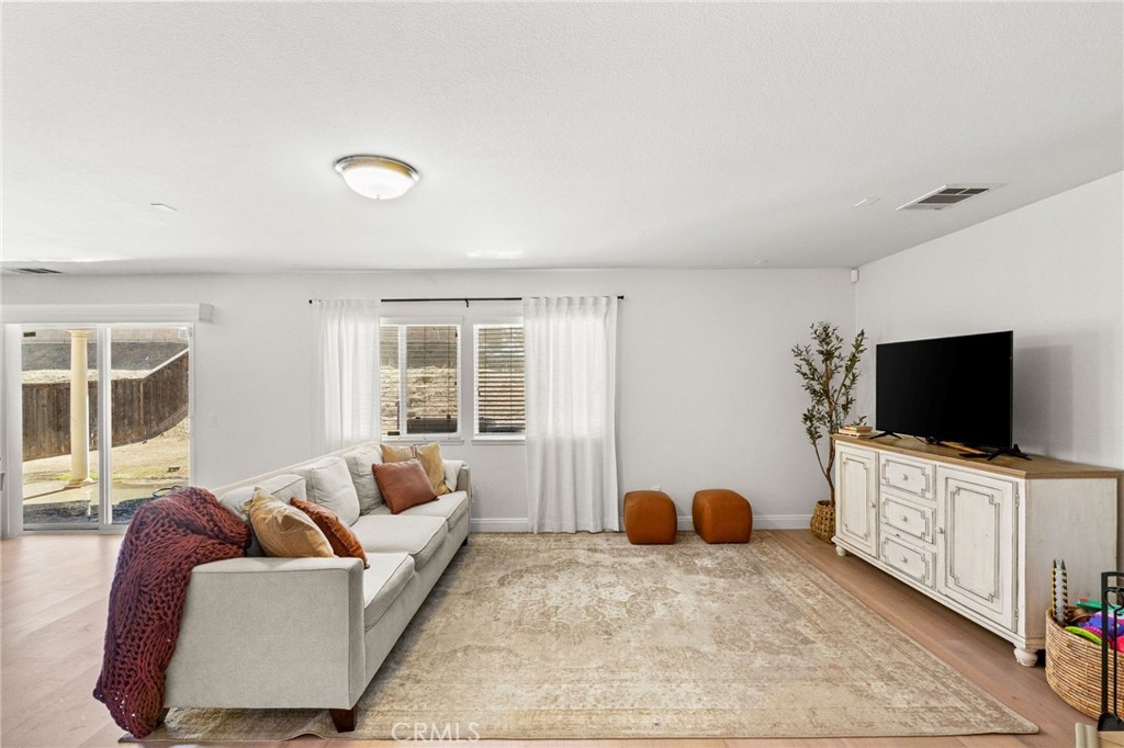 29225 Hydrangea Street Murrieta, CA 92563 - Photo 11 of 38 a bedroom with furniture and a flat screen tv