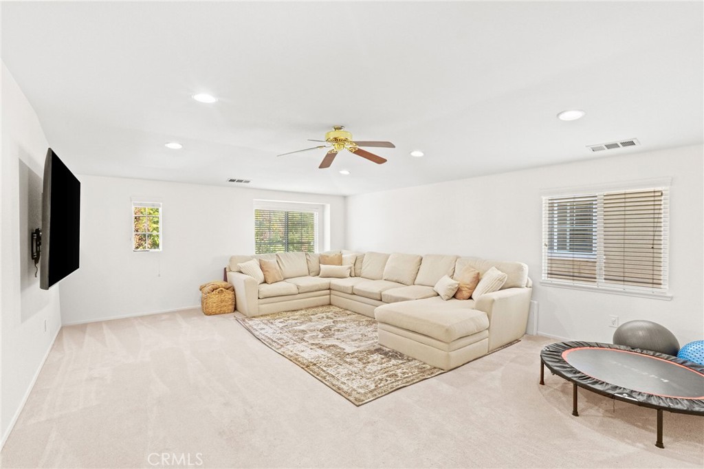29225 Hydrangea Street Murrieta, CA 92563 - Photo 14 of 38 a living room with furniture and a flat screen tv
