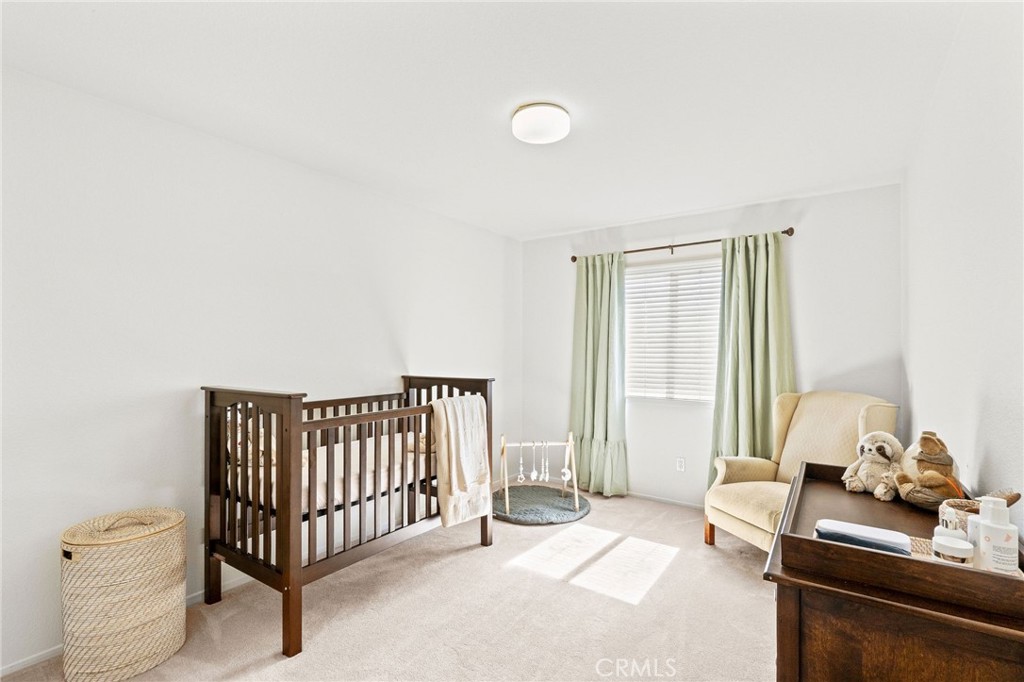 29225 Hydrangea Street Murrieta, CA 92563 - Photo 16 of 38 a spacious bedroom with a bed and a window