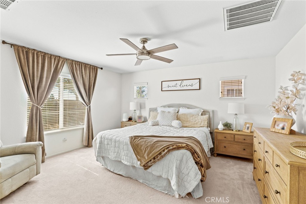 29225 Hydrangea Street Murrieta, CA 92563 - Photo 18 of 38 a bedroom with a bed couch and a large window