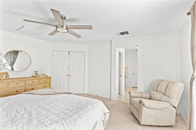 a bedroom with a bed couch and window