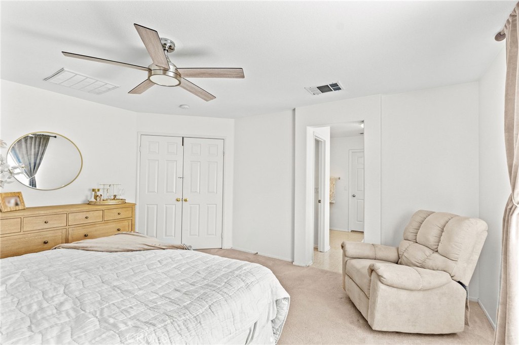 29225 Hydrangea Street Murrieta, CA 92563 - Photo 19 of 38 a bedroom with a bed couch and window