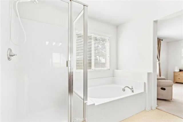 a bathroom with a bathtub and a shower